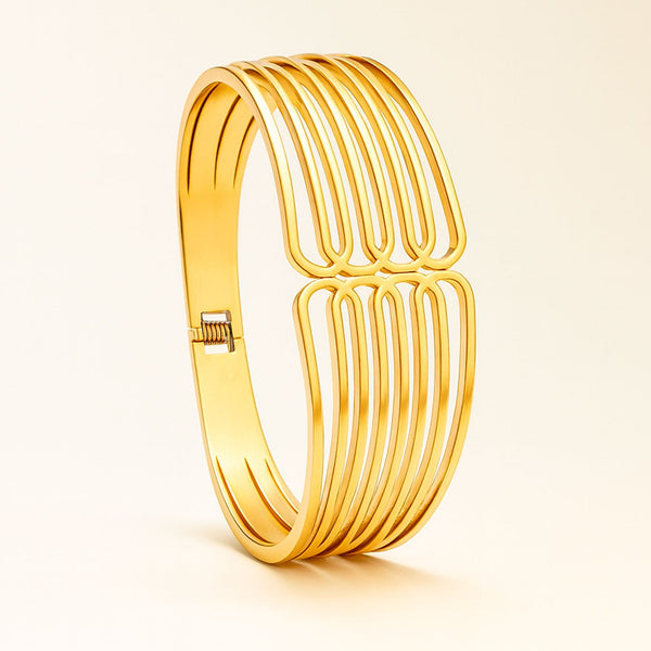 Gold bracelet on a light beige background